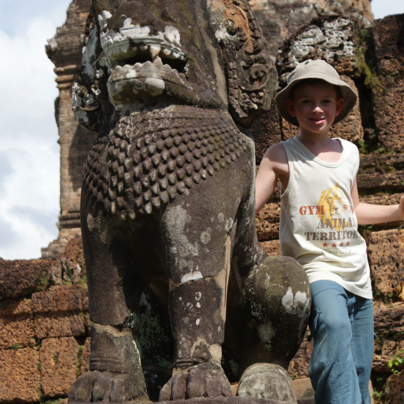 child in cambodia at statue