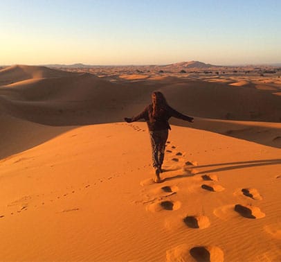woman walking through desert