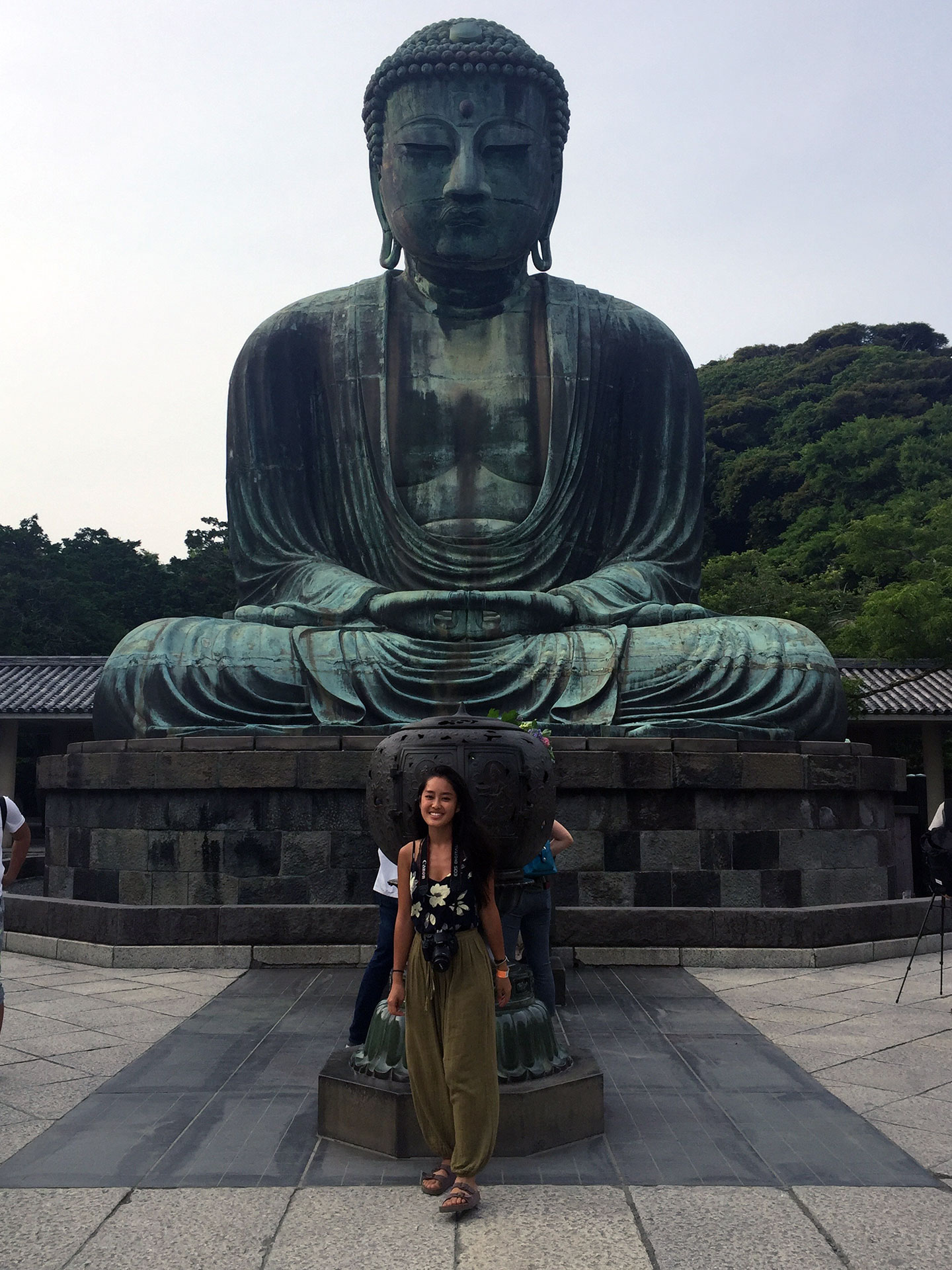 woman posing in front of great buddha in japan