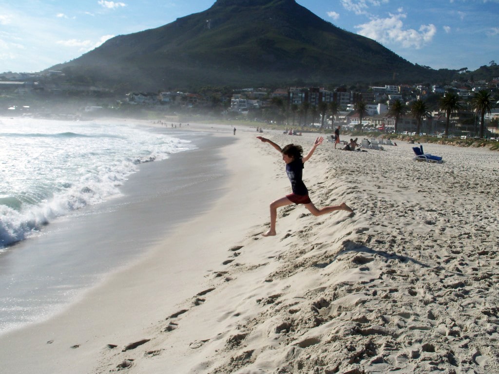 child running on beach south africa