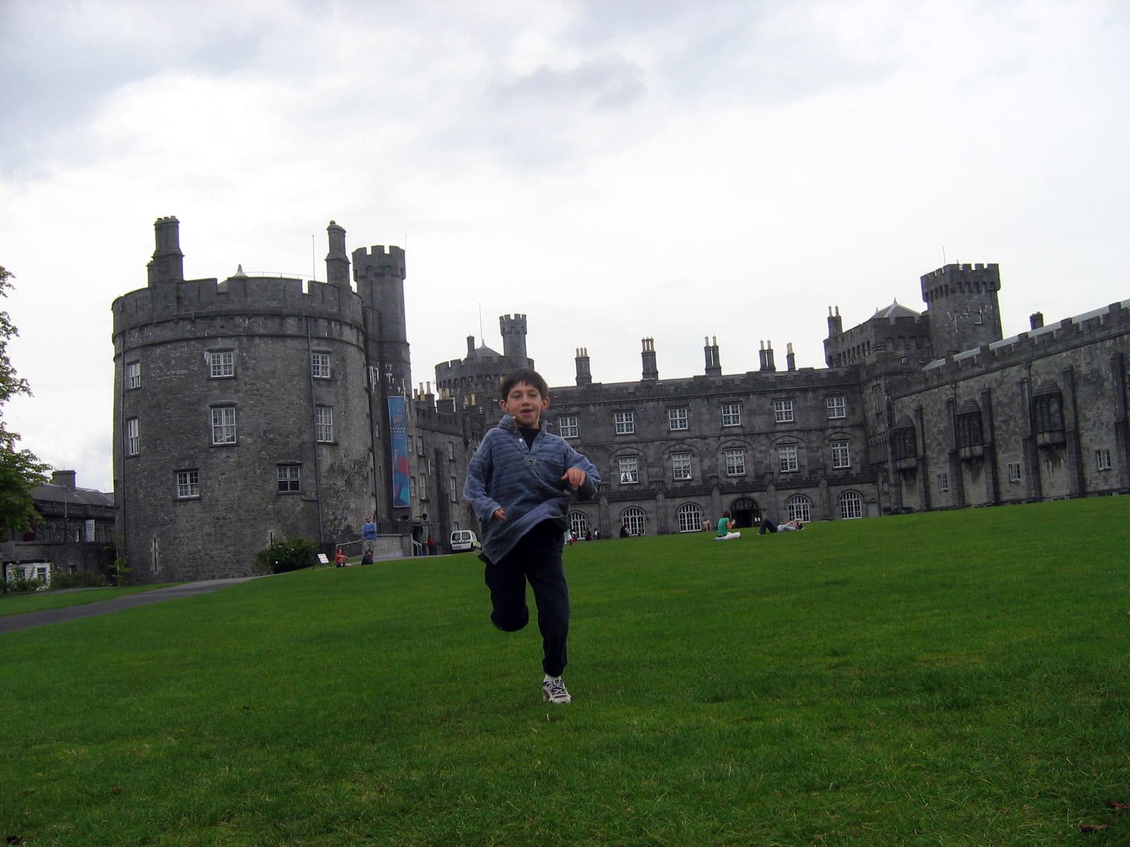 boy running in front of castle in ireland