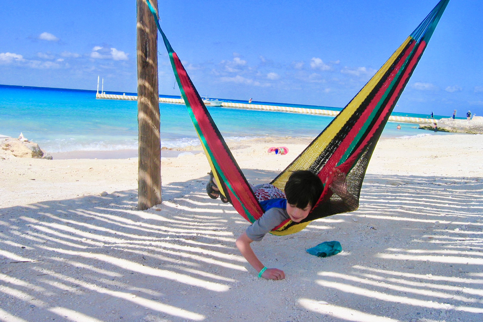 boy on hammock at beach in mexico